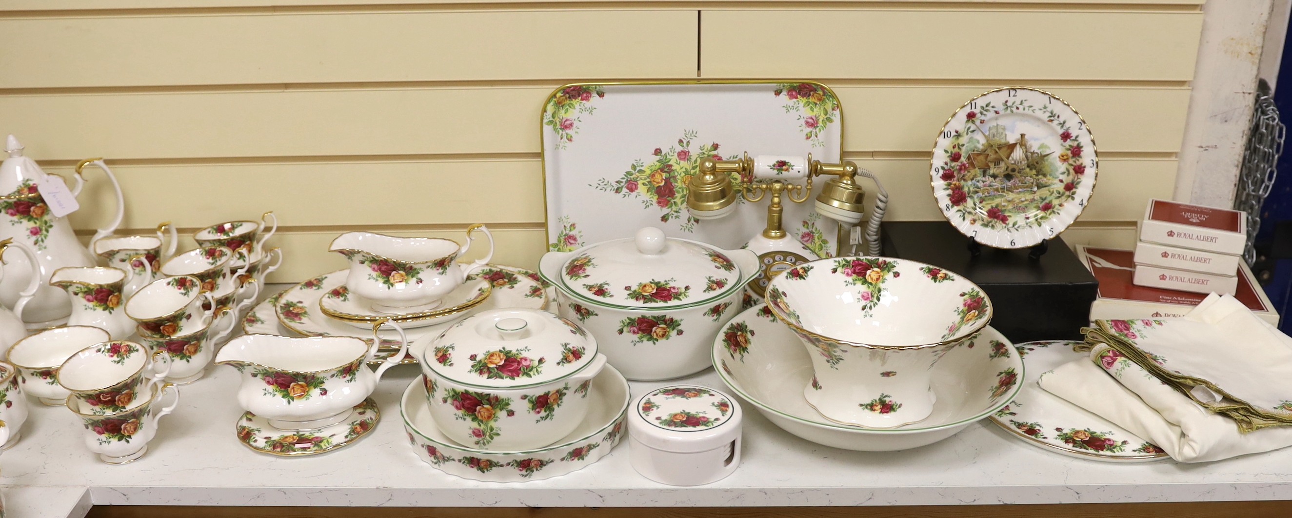 Royal Albert Old Country Roses, a large bone china service for twelve-place setting, and related accessories telephone, wall clock, table mats, napkins and cutlery.